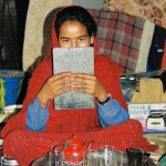 Nomad girl in red dress making tea