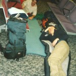 Bill Edwards and Ian Linington camping on the floor at Heathrow airportq