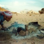 Bill Edwards looking at cooking fire in desert