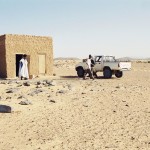 Small desert house with Toyota Hilux parked outside